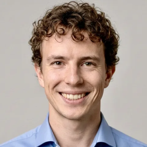 Portrait of Antonius, smiling, in a light blue shirt